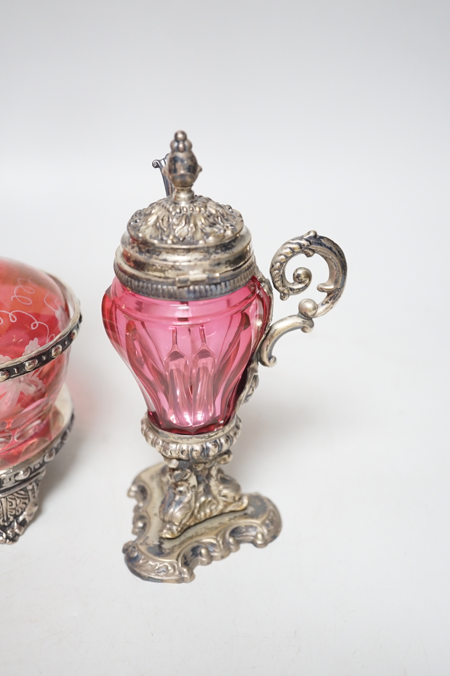 A plated cranberry two bottle and two cruet stand and a similar plated and cranberry mustard, stand 29cm high